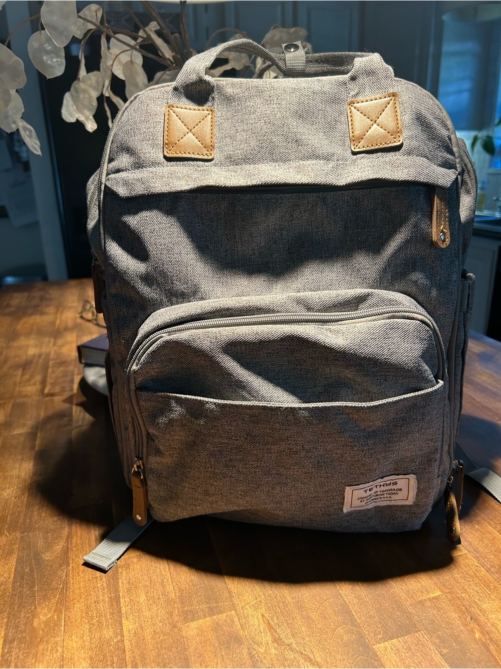 Grey Canvas Backpack/Diaper Bag with Brown Tags and Strap.